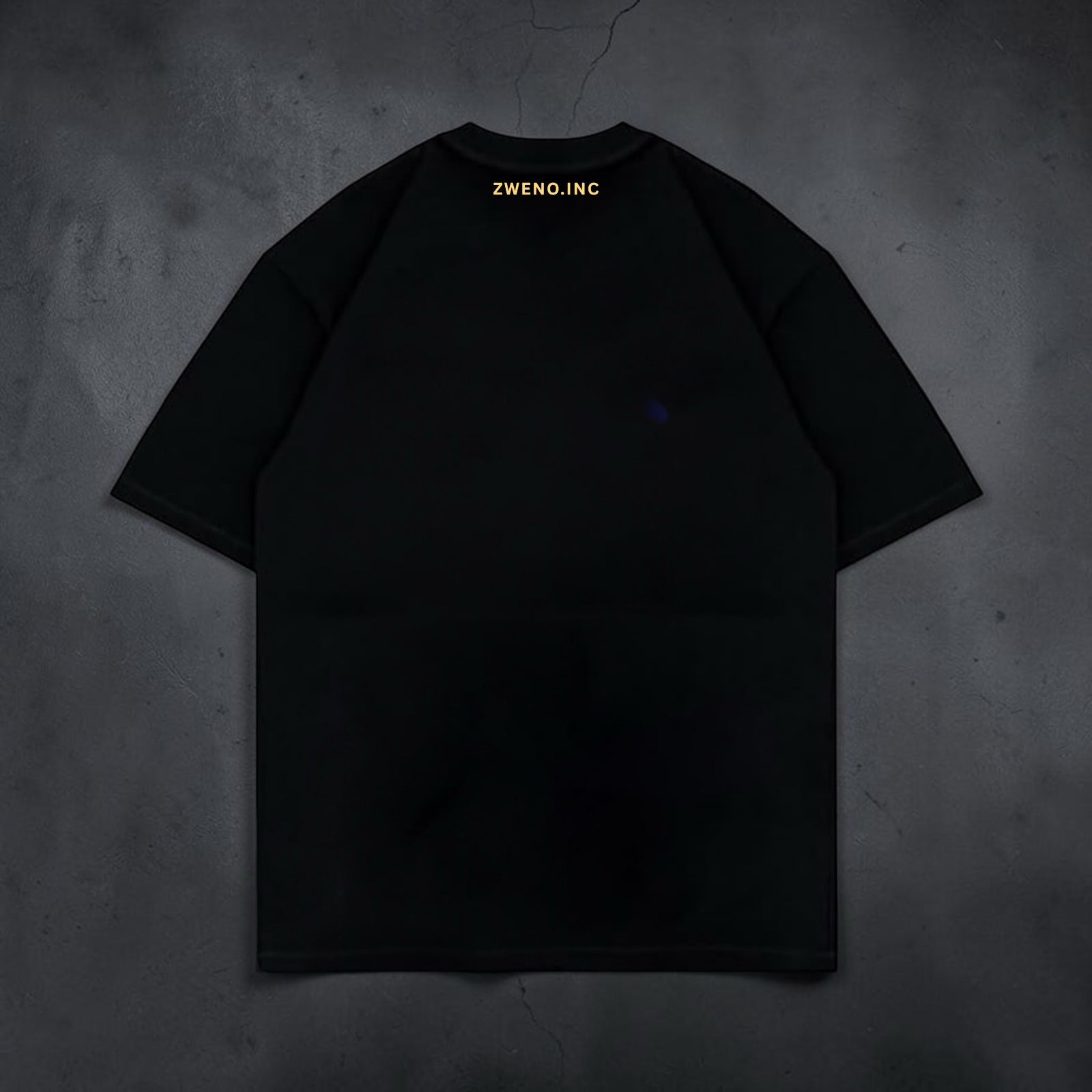Back view of a black ZWENO.INC cotton crew neck t-shirt featuring subtle gold branding at the nape of the neck.